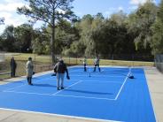 City Council plays first game of Pickleball on new court