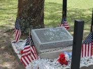 Moon Tree Monument decorated with American flags and red/white/blue flowers