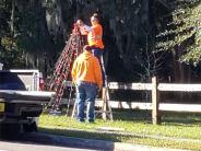 Setting up Christmas lights in front of Nature Park